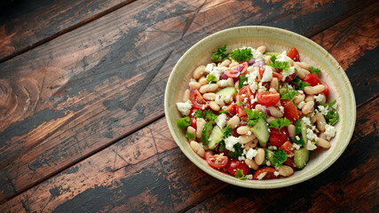 Bean Salad with Cherry Tomatoes, Cucumber, Red onion, Feta cheese and parsley. Healthy vegetarian, vegan diet food