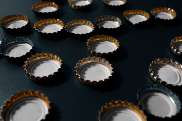 beer lids on a dark surface