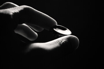 beer cap in hand on black background