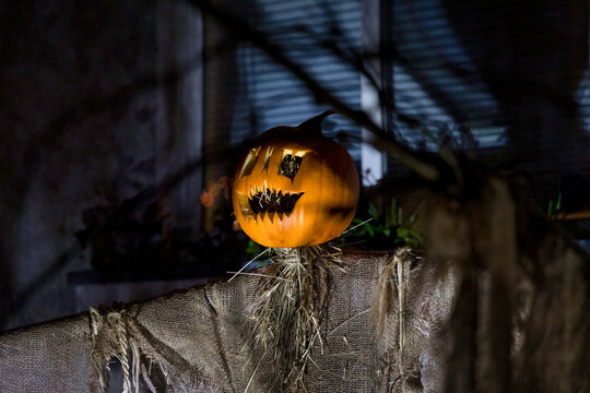 Scary Halloween Scarecrow Casting a Shadow against wall