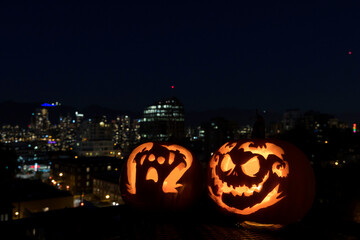 Carved pumpkins with a city view background