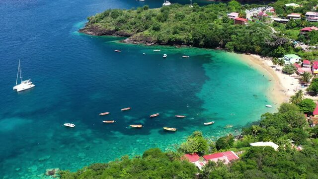 Aerial view of a paradisiac bay anse Dufour Martinique fishing boats clear water and caribbean front beach houses