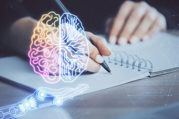 Multi exposure of writing hand on background with brain hologram. Concept of learning.