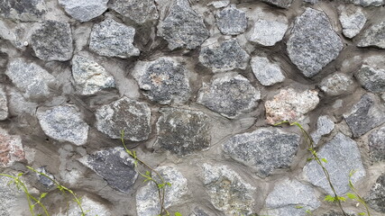 Granite masonry. Wall of granite stones. Vintage background