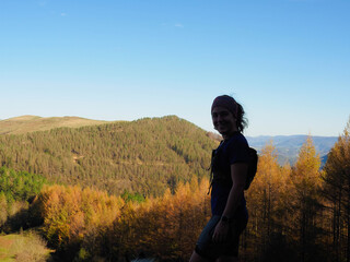 young woman with a mountain background in autumn