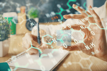 Science formula hologram over woman's hands taking notes background. Concept of study. Double exposure