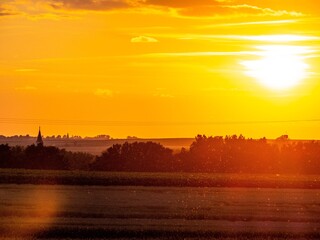 The sunset, arable land and church.