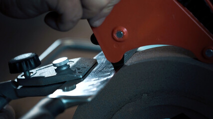 Man adjusts the angle on a grinder using an instrument