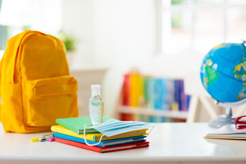 Backpack of school child. Face mask and sanitizer.