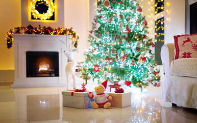 Christmas tree and fireplace in living room.