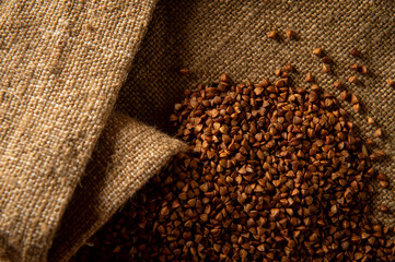 Buckwheat. Buckwheat on sacking. Raw buckwheat groats. Whole grain porridge.