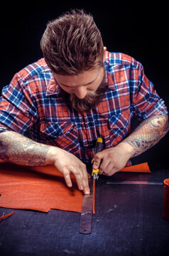 Leather cutter focusing on his work
