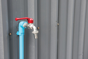 Obraz na płótnie Canvas steel water faucet or tab at metal zinc wall
