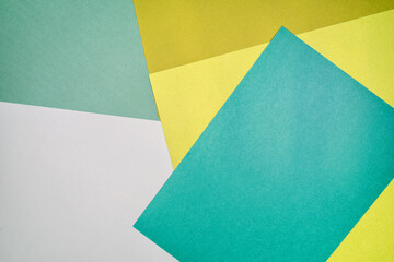 Multi colored abstract paper of pastel yellow,aqua, green colors palette, with geometric shape.