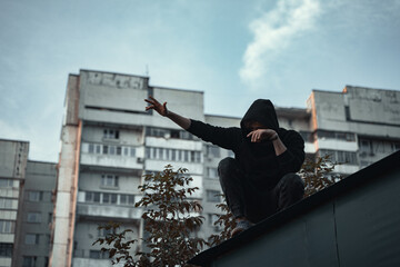  the man in black is sitting on the roof © Женя Шаповалов