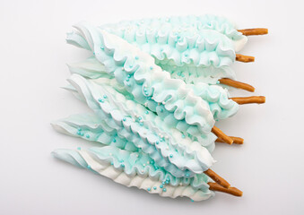delicious sweet meringue on a stick in the shape of a feather