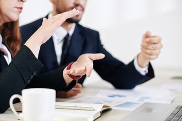 Fototapeta premium Businesswoman showing size of product that company is selling at meeting, selective focus