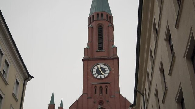 Clocktower on St Johann Baptist Church, East Munich, Germany. Slow Motion Close Up Approach