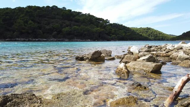 Glistening water on a rocky beach near Soline on Mljet Island in Croatia in the Adriatic Sea