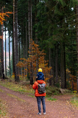 Fototapeta premium mother and son walk through the forest in autumn
