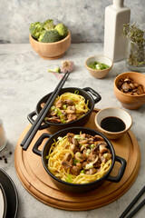 Egg noodles in black bowls, asian food