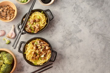 Egg noodles in black bowls, asian food, top view