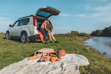 couple having picnic date at river beach