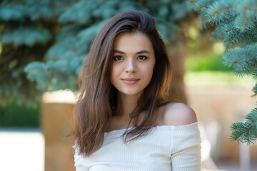 portrait of brunette woman in summer park