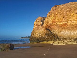 Hinking at the beach of Praia Maria Luisa, Olhos da Agua, Albufeira, at the Algarve coast of Portugal