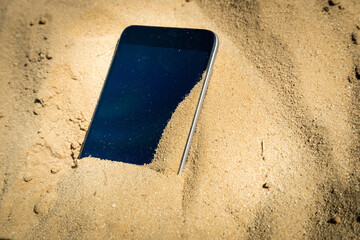 mobile phone lost and lying in the sand