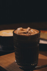 Glass of cocoa with marshmallows on a dark background
