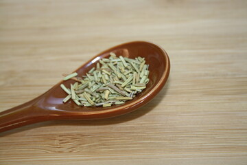 Spice rosemary in a ceramic spoon