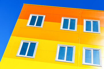 Bright colorful apartment building against blue sky