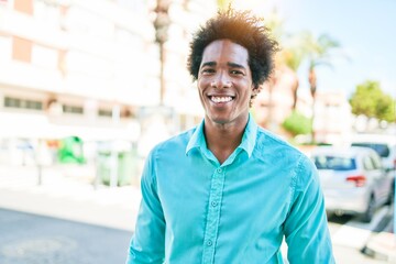 Young handsome african american man wearing casual clothes smiling happy. Standing with smile on face walking at town street.