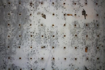 evocative image of texture of perforated metal plate