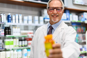 Fototapeta na wymiar Pharmacist holding a jar of pills
