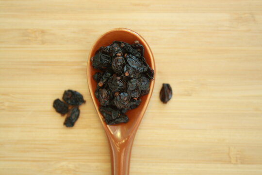 Barberry berries in a ceramic spoon.