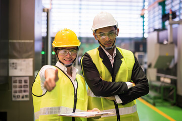 Female engineer and factory manager thumb up