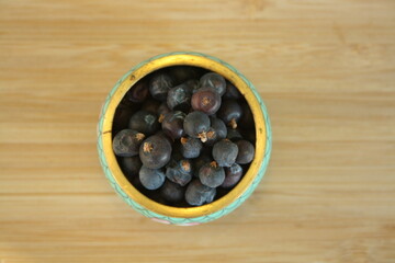 Ceramic plate with juniper berries.