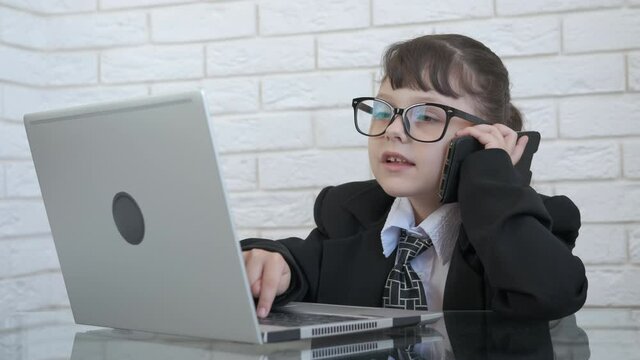 Business for children at home. A nice little boss in a suit speak on phone and start to scream and press a computer button nervously