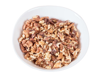 Peeled walnuts are in a round plate.