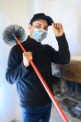 Young chimney sweep portrait in a house wearing a mask due to coronavirus emergency