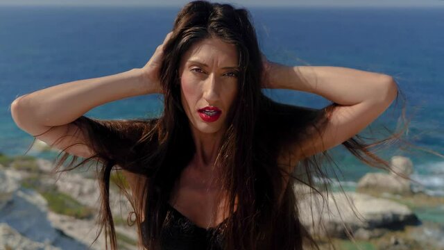Portrait of Sexy Caucasian Female Model Posing to Camera Changing Poses and Face Expression in Exterior by Sea, Full Frame