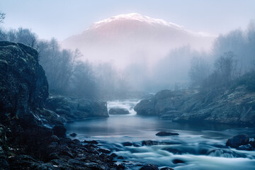 The mist is leaving and the sun is rising. Autumn in the Hemsedal in Norway mountains. Shot with long exposure.