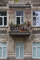 Fototapeta na wymiar The facade with flowers on the balcony.