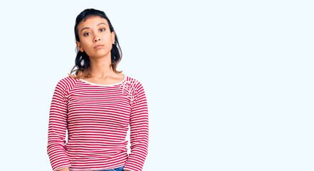 Young woman wearing casual clothes with serious expression on face. simple and natural looking at...