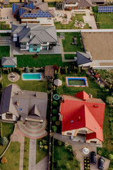 Fototapeta na wymiar Aerial top view of a house with paved yard with green grass lawn with concrete foundation floor