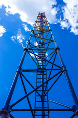 Long metal stairway (staircase). Ladder leading to blue sky as symbol of career ladder