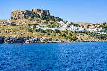 Fototapeta na wymiar The quarter of the most respectable villas in Lindos is located directly above the harbor on the cliff side of the acropolis of the ancient city of Lind 