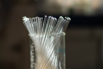 Various clean NMR tubes in a beaker in a chemistry laboratory for biotechnology research for drug